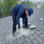 Noble Air technician cleans dryer vent from the roof