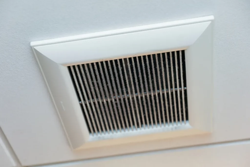 Closeup of clean metal ductwork in a modern air ventilation system related to mold concerns.