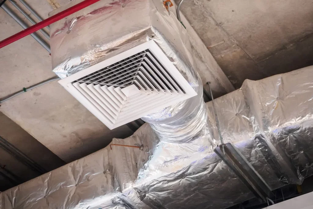 Ceiling air duct in a large shopping mall, highlighting potential mold issues affecting air quality.