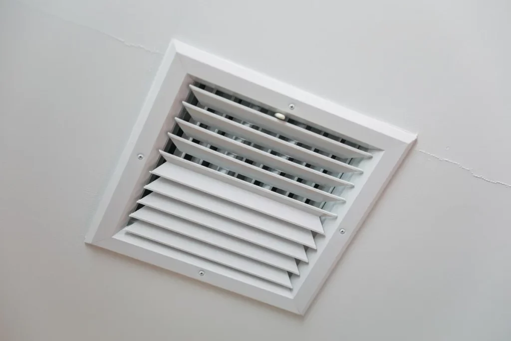 Closeup of clean metal ductwork in a modern air ventilation system highlighting the need for plenum mold cleaning.