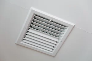 Closeup of clean metal ductwork in a modern air ventilation system highlighting the need for plenum mold cleaning